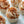 Load image into Gallery viewer, A photo of several Biscoff cupcakes with buttercream frosting and a sprinkle of Biscoff crumb on top, set on a light background.
