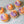 Load image into Gallery viewer, Halloween character cupcakes with vanilla sponge, purple and orange buttercream swirls and spooky ghost and skeleton decorations.

