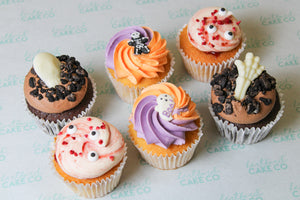 Halloween cupcake box with chocolate ganache cupcakes, strawberry Victoria sponge cupcakes and spooky Halloween character cupcakes.