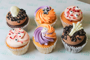 Halloween cupcake box with chocolate ganache cupcakes, strawberry Victoria sponge cupcakes and spooky Halloween character cupcakes.